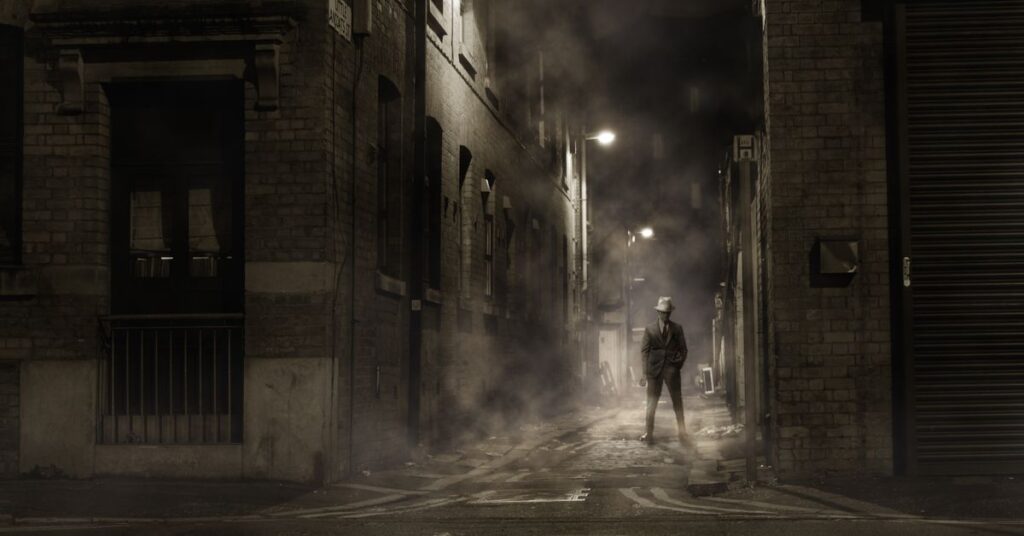 Best thriller movies: a lone figure in a misty dark alley at night