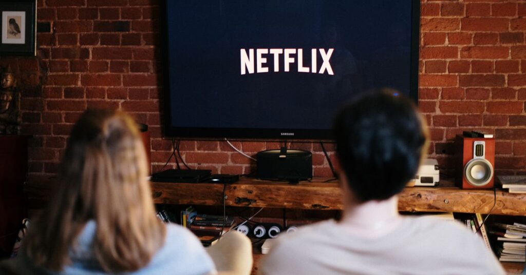 Best web series: a couple watching a streaming show on TV
