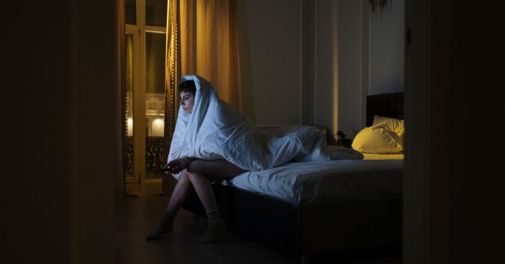 Hotstar best series hindi: person watching a streaming series on a TV at night