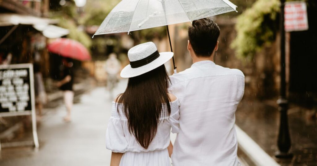 Kdrama romance: a couple walking together under an umbrella