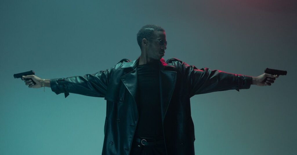 Movies like John Wick: a man in a leather coat aiming two pistols