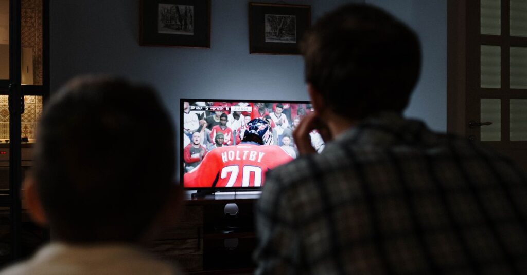 Friends watching South Indian Hindi dubbed movies on a TV at home